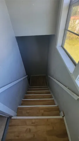 en empty room with windows and ceiling fan