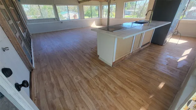 a kitchen with a sink and large window