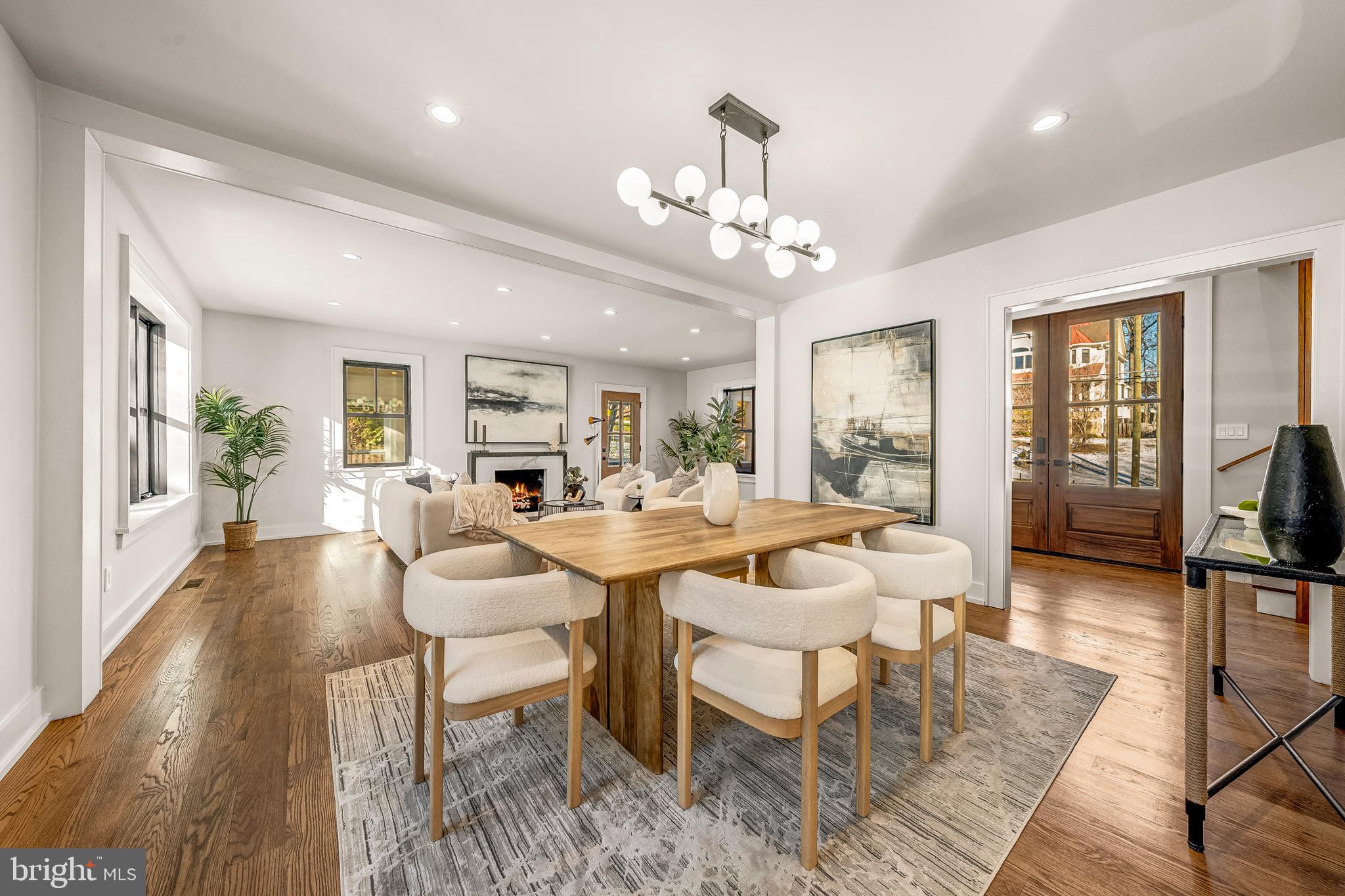 5921 Chesterbrook Road McLean, VA 22101 - Photo 14 of 76 a view of a dining room with furniture a chandelier and wooden floor