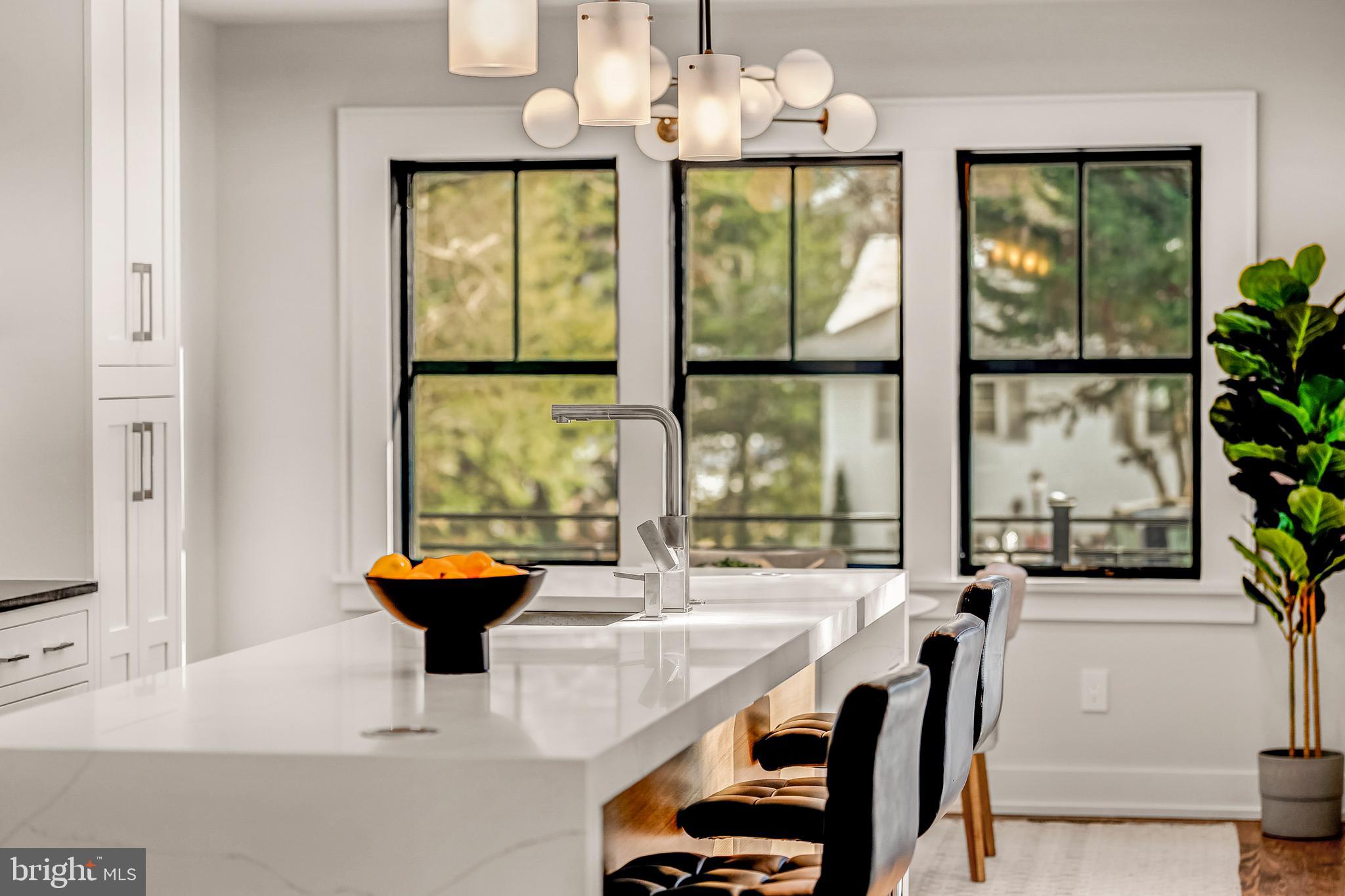 5921 Chesterbrook Road McLean, VA 22101 - Photo 26 of 76 a view of a dining room with furniture a chandelier and large windows