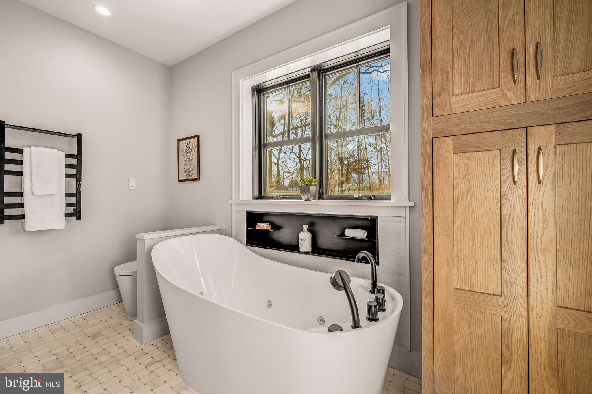 5921 Chesterbrook Road McLean, VA 22101 - Photo 49 of 76 a bathroom with a bathtub and window
