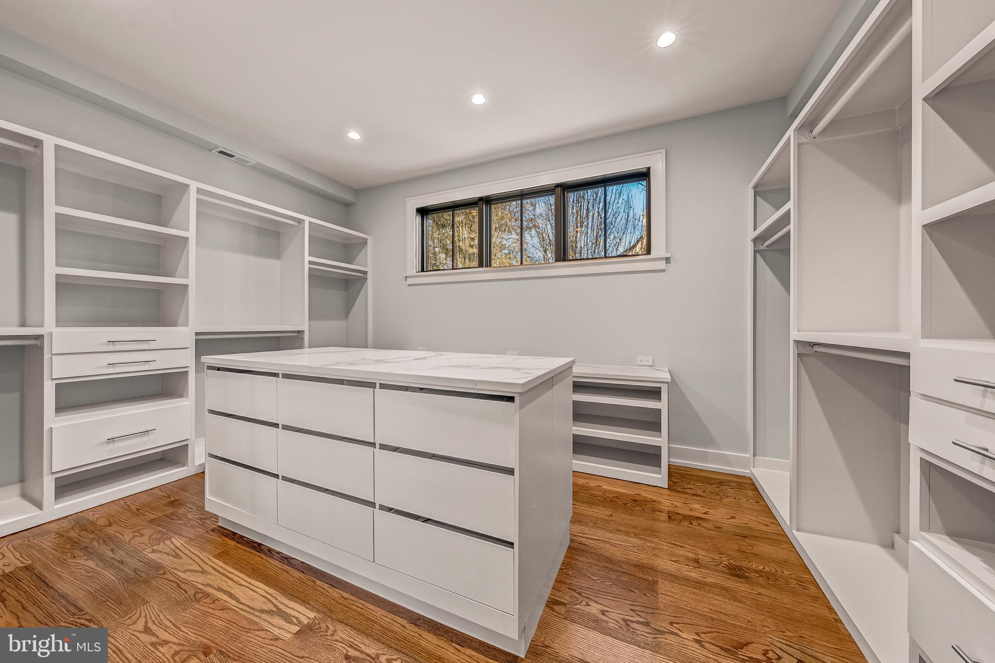 5921 Chesterbrook Road McLean, VA 22101 - Photo 50 of 76 a view of walk in closet with empty racks