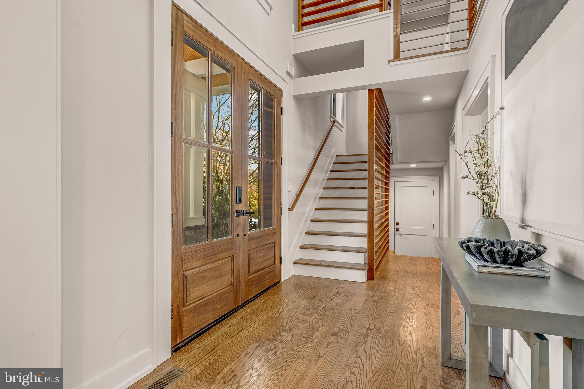 5921 Chesterbrook Road McLean, VA 22101 - Photo 5 of 76 a view of a hallway with wooden floor and staircase