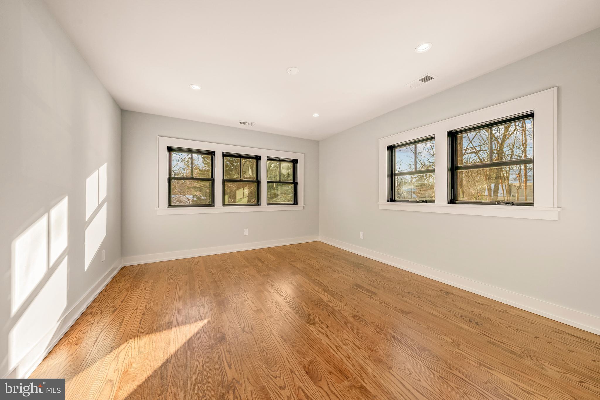 5921 Chesterbrook Road McLean, VA 22101 - Photo 53 of 76 an empty room with wooden floor and windows
