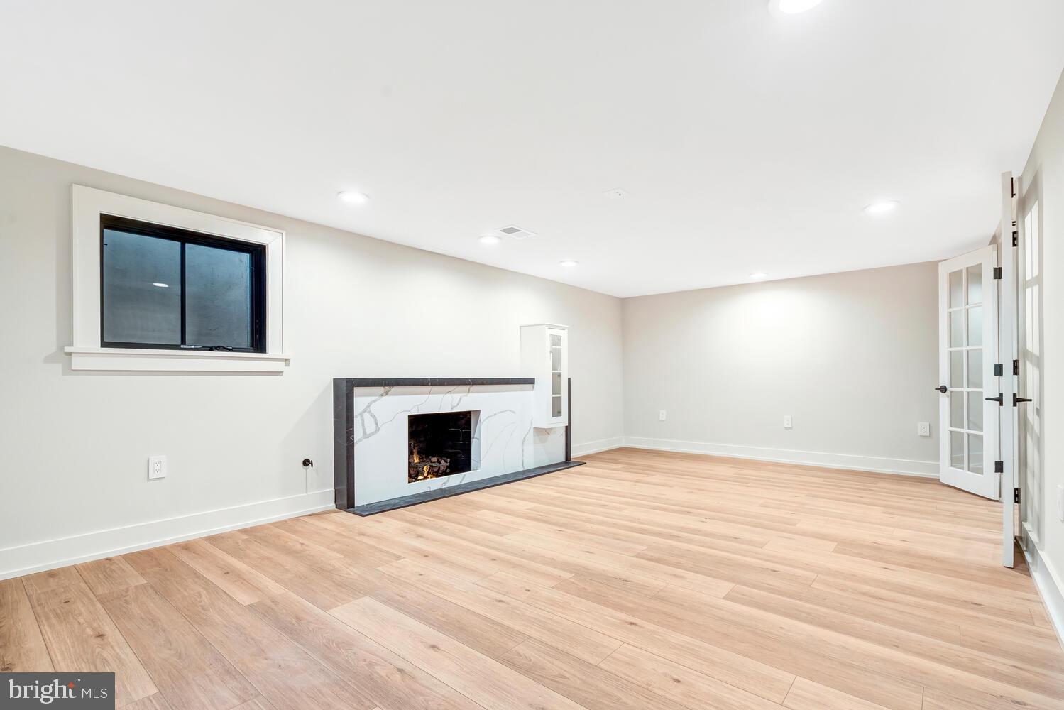 5921 Chesterbrook Road McLean, VA 22101 - Photo 67 of 76 a view of empty room with wooden floor and fireplace