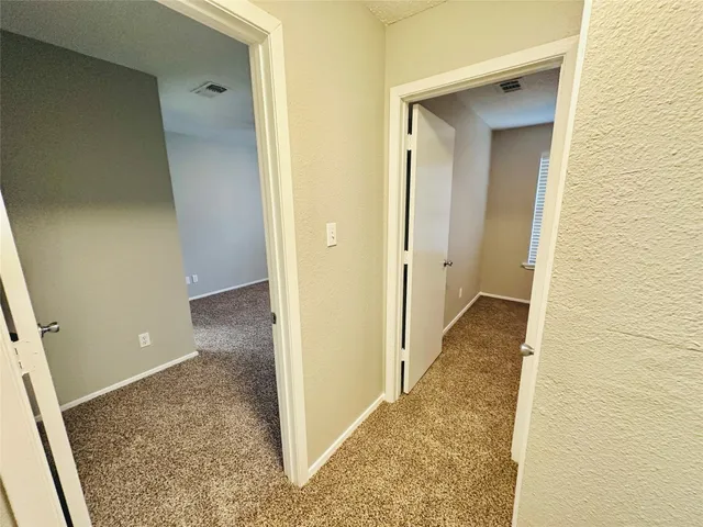 a view of a room with a sink and cabinets