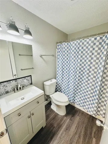 an empty room with a ceiling fan and a window