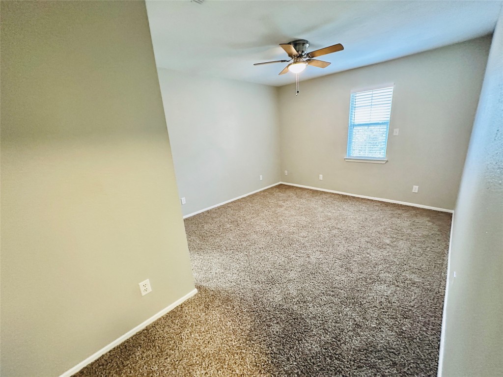 1314 Southport Drive, Unit C Austin, TX 78704 - Photo 19 of 22 an empty room with a ceiling fan and a window