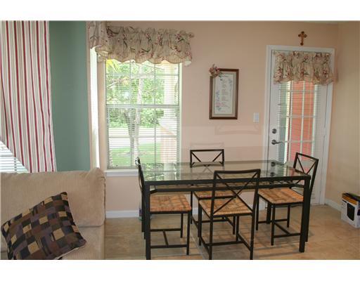 1335 Crystal Way, Unit J Delray Beach, FL 33444 - Photo 4 of 6 a view of a dining room with furniture and a large window