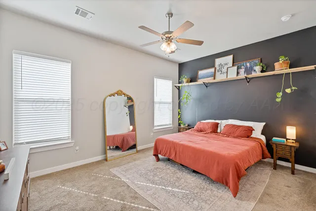 a bedroom with a bed chandelier and window