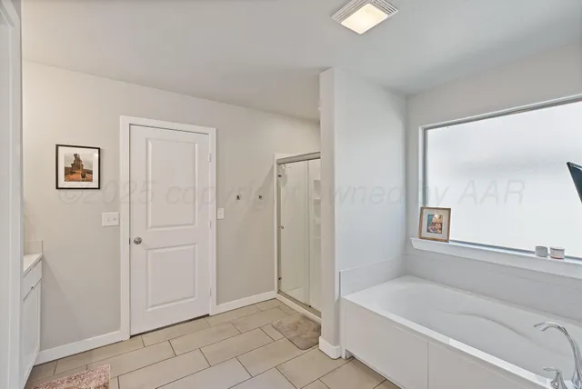 a bathroom with a bathtub and a shower