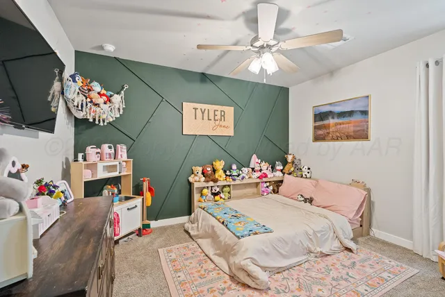a bed room with a bed mirror and a window