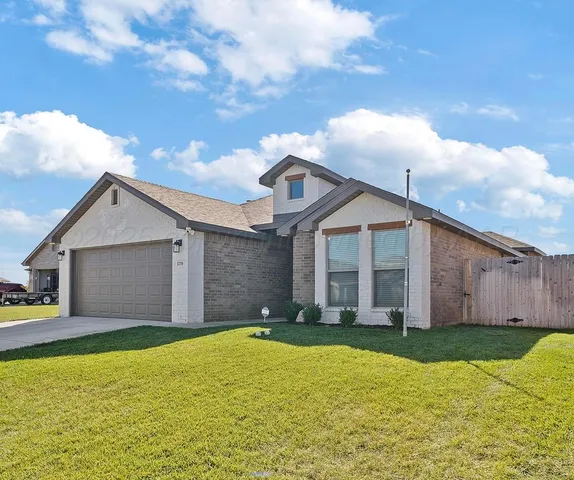 a front view of house with yard and entertaining space
