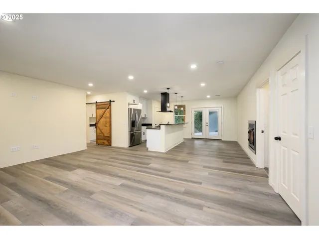 a view of kitchen with refrigerator stove and oven