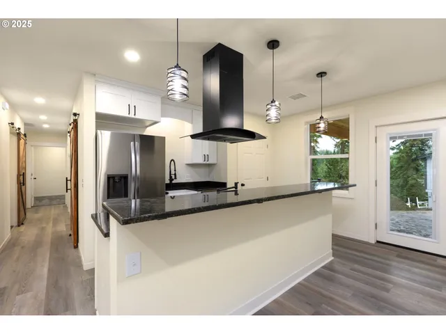 a kitchen with granite countertop cabinets and window
