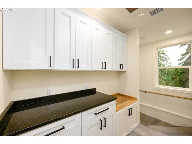 a view of an empty room and wooden floor