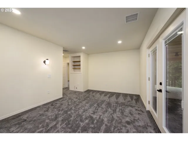 a view of a hallway with cabinets