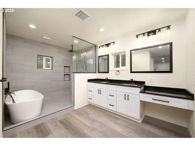 a bathroom with a granite countertop sink mirror and