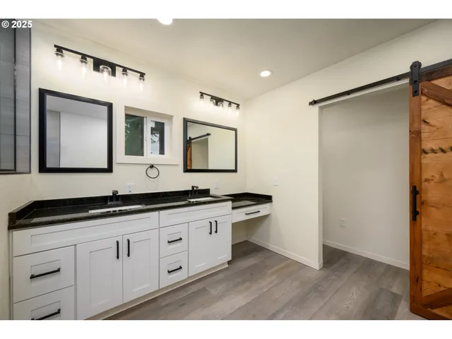 a bathroom with a granite countertop sink mirror and