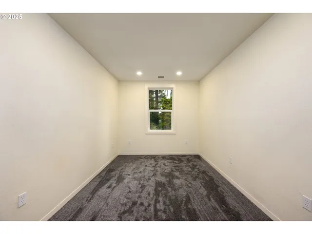 a kitchen with white cabinets and black appliances