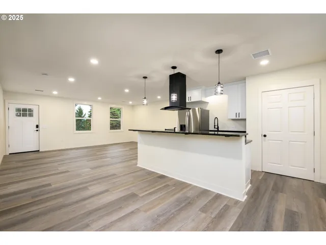 a view of house with backyard and a garden
