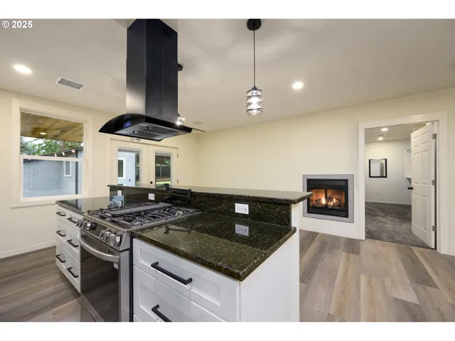 a view of a living room and kitchen with furniture and a view