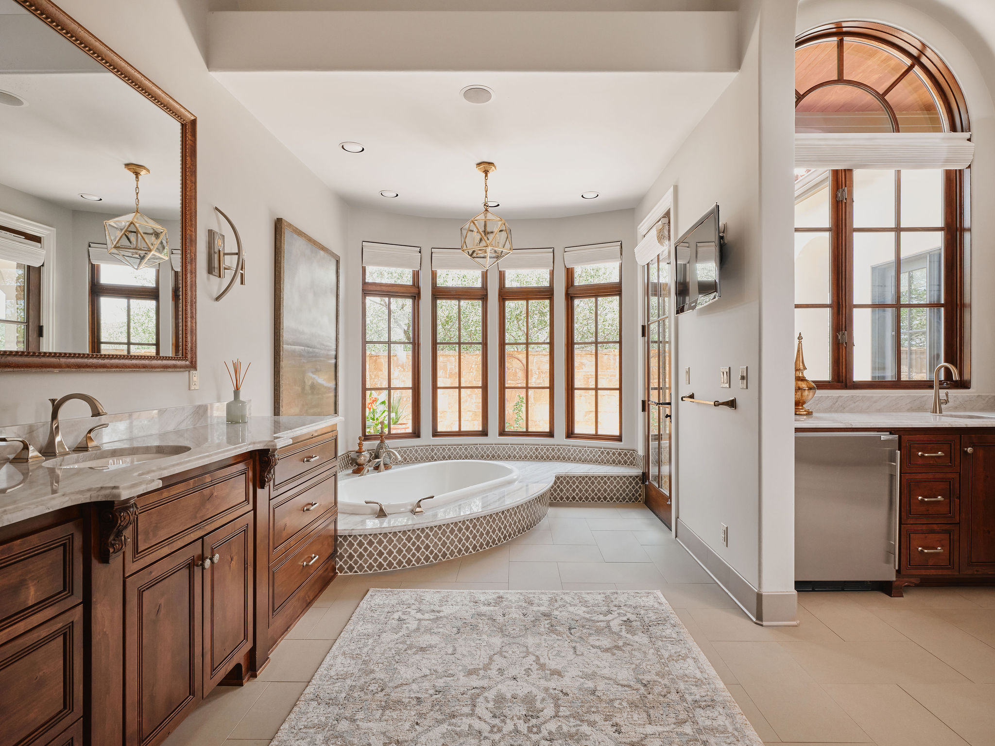 433 Brandon Way Austin, TX 78733 - Photo 17 of 40 Luxurious bathing retreat boasts a deep soaking tub, separate vanities, and abundant natural light.