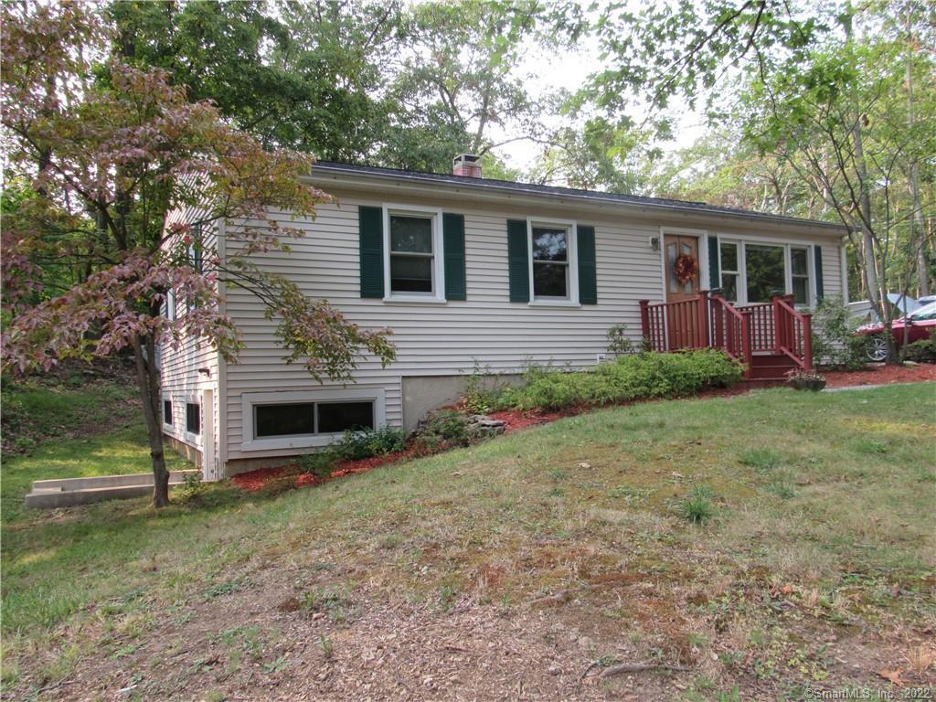 94 Bob Hill Road Ridgefield, CT 06877 - Photo 1 of 1 a front view of house with yard and outdoor seating