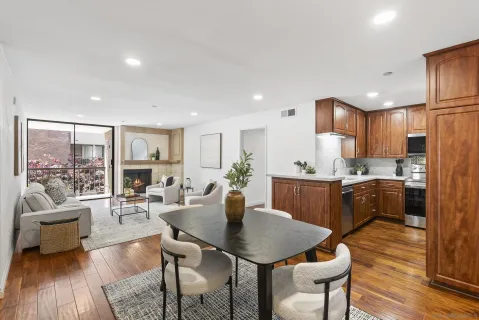 a kitchen with a table chairs refrigerator and cabinets