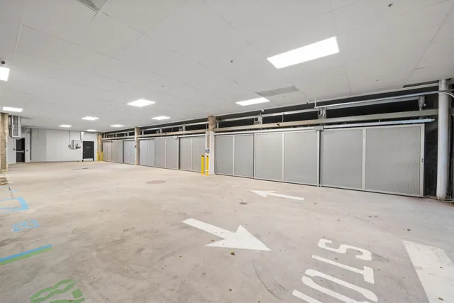 a view of an empty room with a kitchen