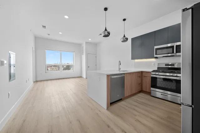 a kitchen with stainless steel appliances a white stove top oven and a refrigerator