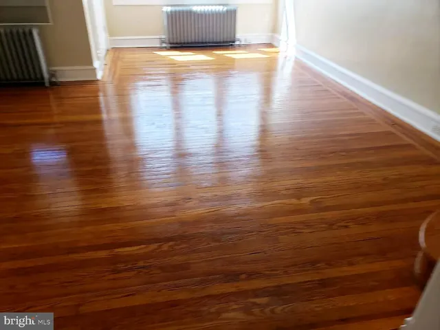 a view of a room with wooden floor