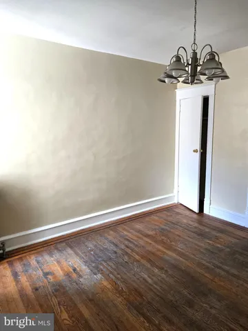 a view of a room with wooden floor and windows