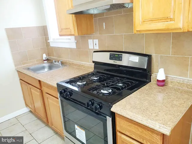 a kitchen with a stove and a sink