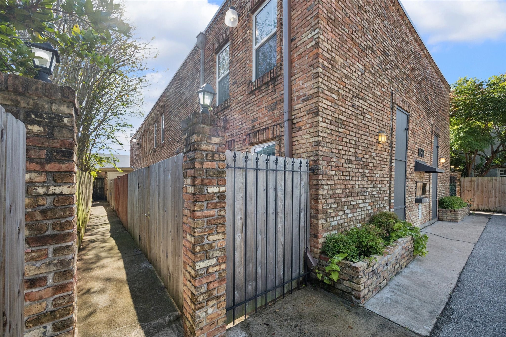 1531 Marshall Street, Unit 1 Houston, TX 77006 - Photo 3 of 19 The charming brick exterior and private side walkway guide you toward your own entrance, creating a quiet, tucked-away feel in the middle of the city.