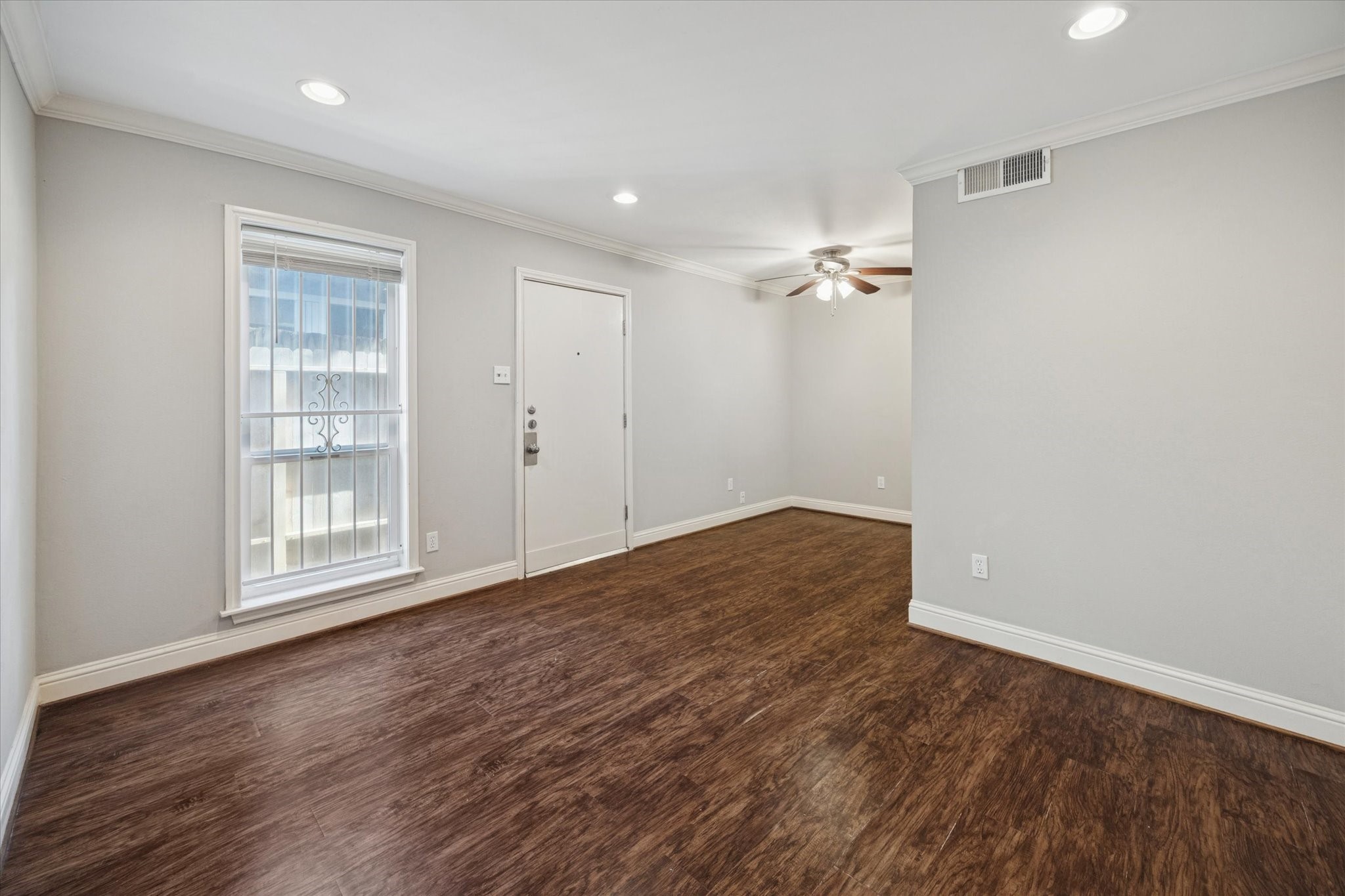 1531 Marshall Street, Unit 1 Houston, TX 77006 - Photo 5 of 19 Step into a bright, updated living room with fresh neutral finishes, wood-look flooring, chic recessed lighting and plenty of natural light. It's an inviting start to this beautiful Montrose condo.