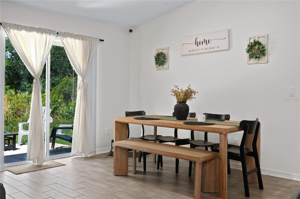 2518 Hoptree Lane Edgewater, FL 32141 - Photo 11 of 28 a view of a dining room with furniture window and wooden floor