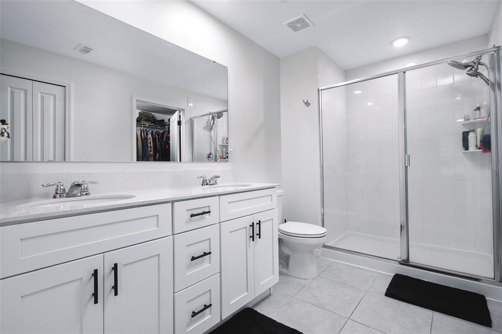2518 Hoptree Lane Edgewater, FL 32141 - Photo 18 of 28 a bathroom with a double vanity sink toilet and shower