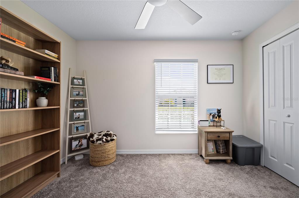 2518 Hoptree Lane Edgewater, FL 32141 - Photo 20 of 28 a room with furniture and a book shelf