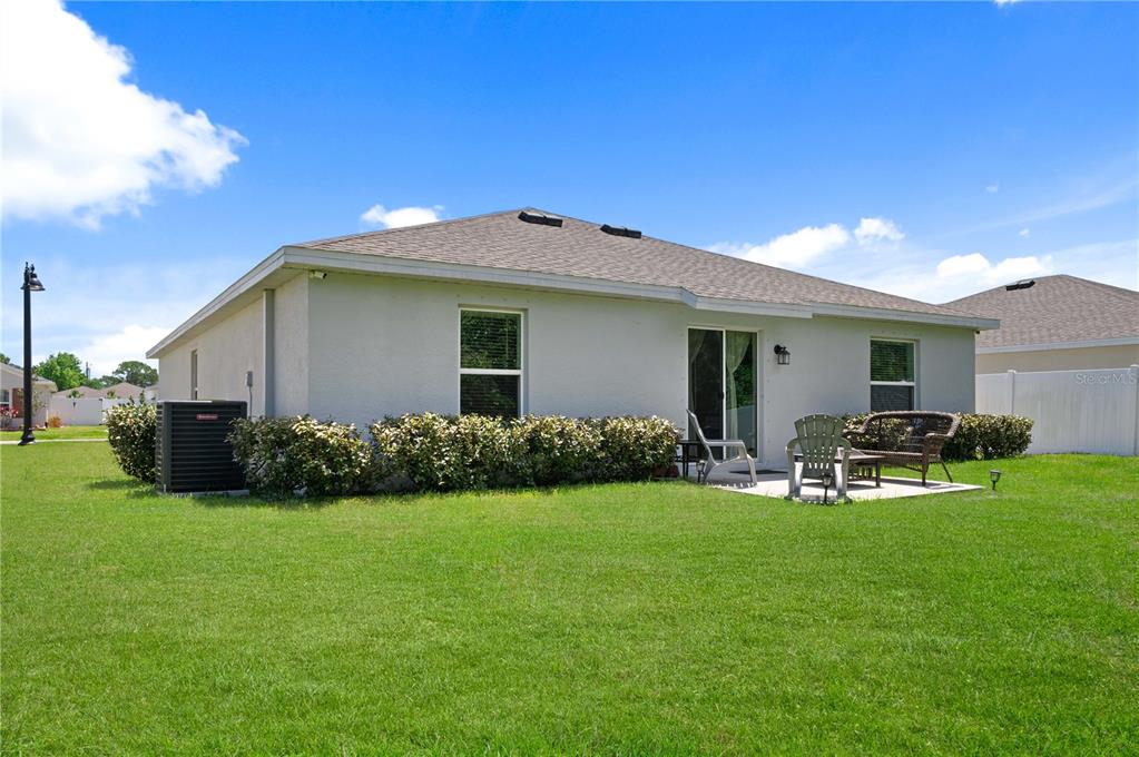 2518 Hoptree Lane Edgewater, FL 32141 - Photo 26 of 28 a front view of house with yard and green space