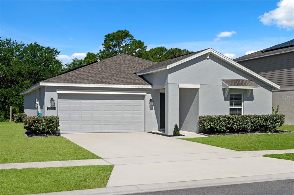 2518 Hoptree Lane Edgewater, FL 32141 - Photo 27 of 28 a front view of a house with a yard