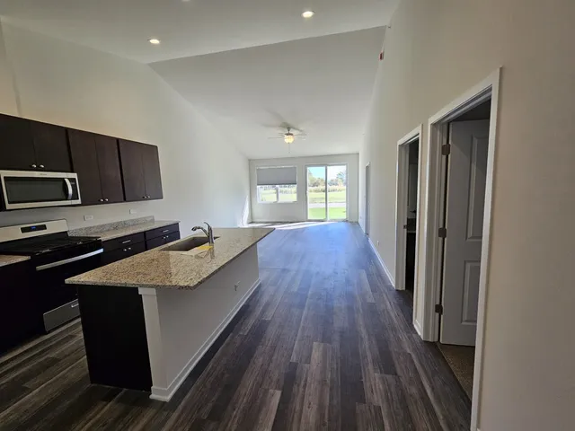 a kitchen with counter top space a sink and stainless steel appliances