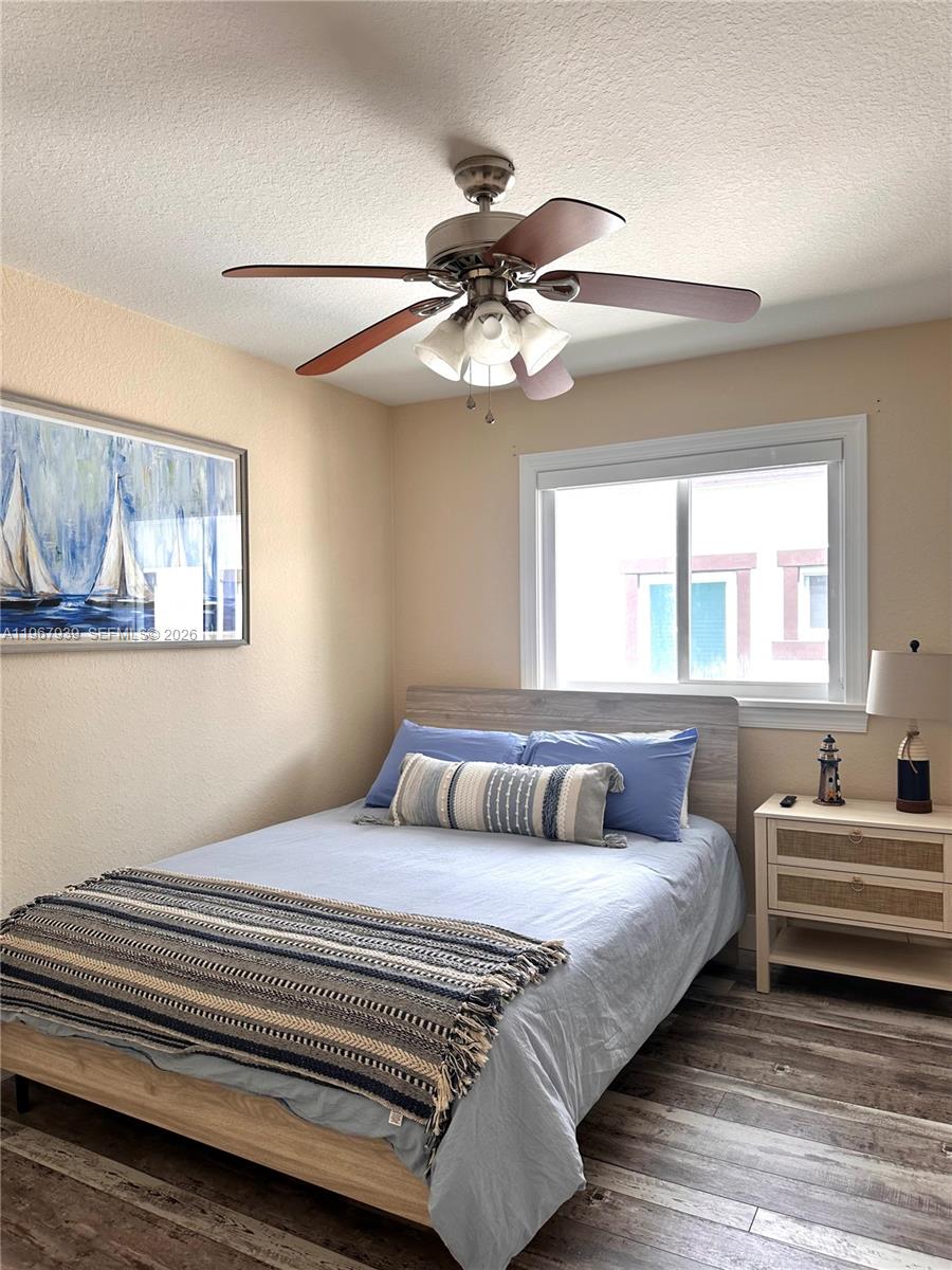 24 Tarpon Avenue Key Largo, FL 33037 - Photo 12 of 22 a bedroom with a bed and a chandelier