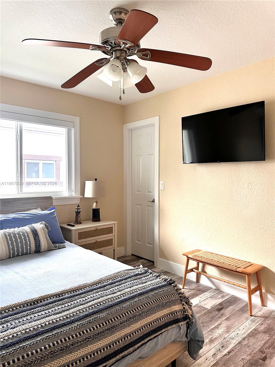 24 Tarpon Avenue Key Largo, FL 33037 - Photo 13 of 22 a bedroom with a bed and a flat screen tv