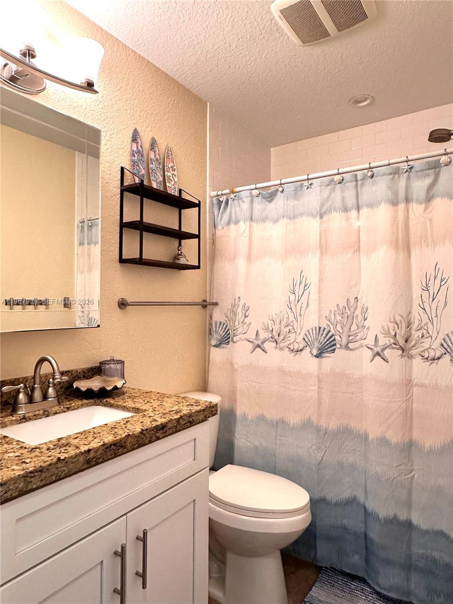 24 Tarpon Avenue Key Largo, FL 33037 - Photo 15 of 22 a bathroom with a sink toilet and shower