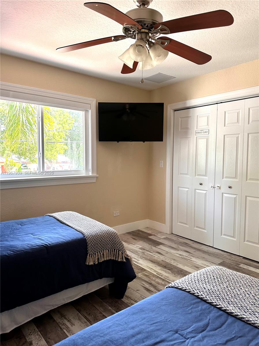 24 Tarpon Avenue Key Largo, FL 33037 - Photo 20 of 22 a bedroom with a bed ceiling fan and a window