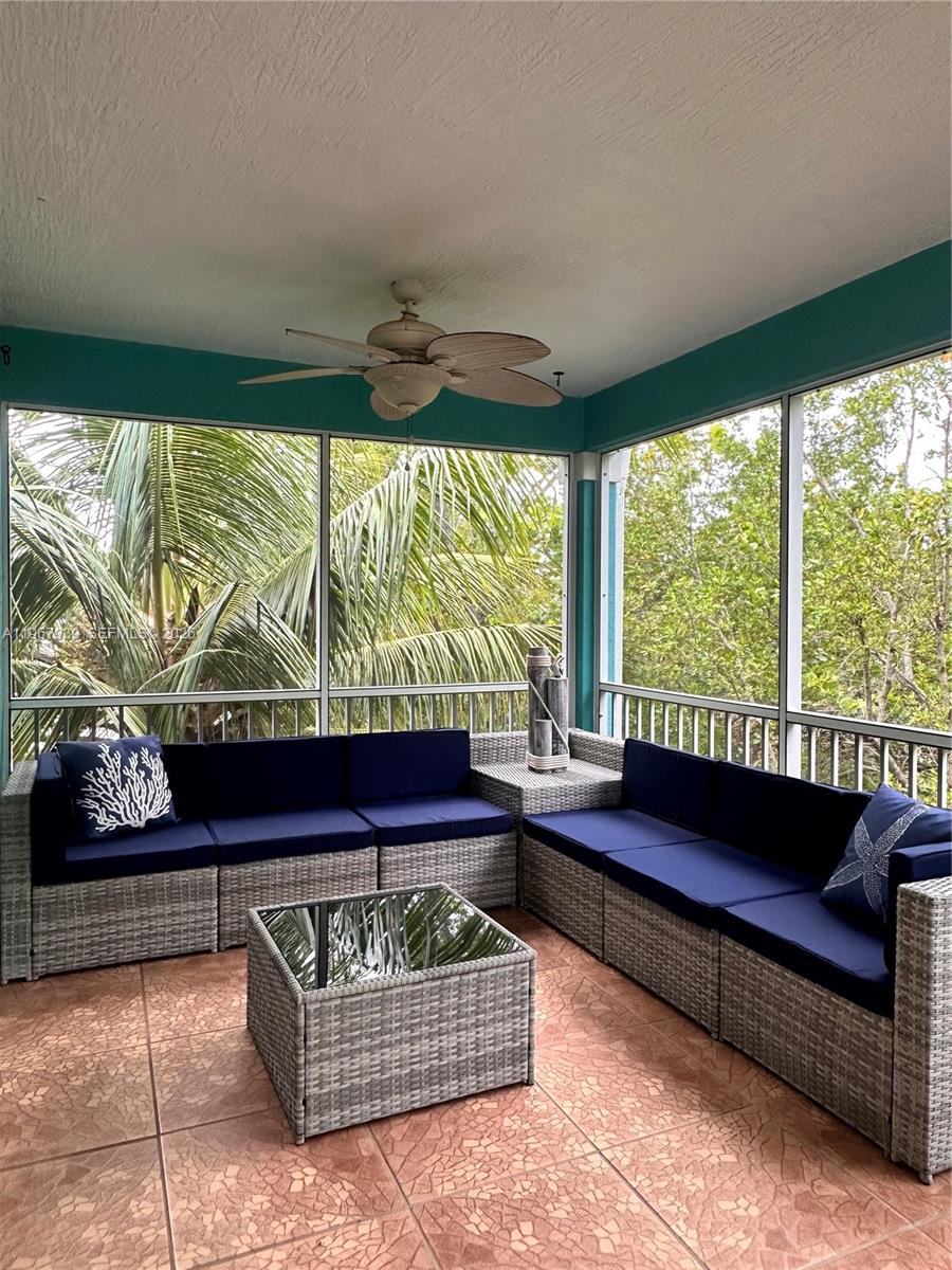 24 Tarpon Avenue Key Largo, FL 33037 - Photo 21 of 22 a living room with furniture and a large window