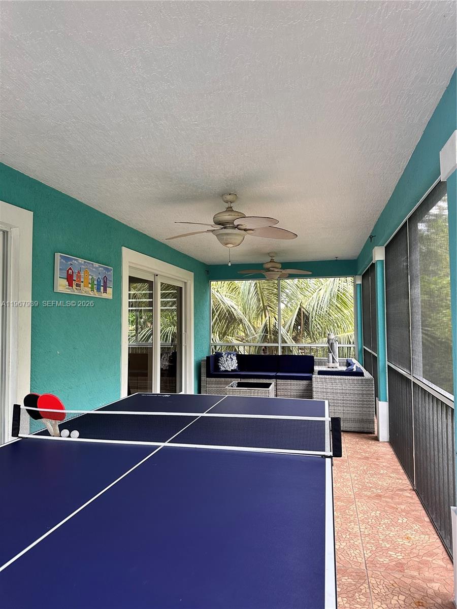 24 Tarpon Avenue Key Largo, FL 33037 - Photo 22 of 22 a view of a patio with a table chairs and a barbeque