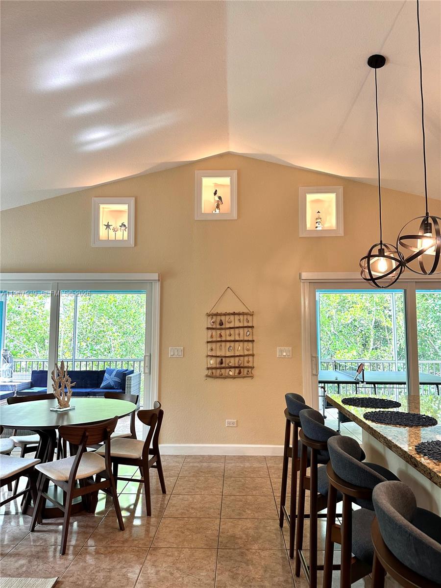 24 Tarpon Avenue Key Largo, FL 33037 - Photo 3 of 22 a view of a dining room with furniture window and outside view