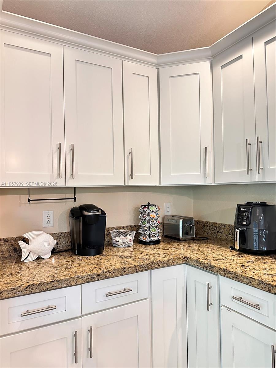 24 Tarpon Avenue Key Largo, FL 33037 - Photo 5 of 22 a kitchen with granite countertop white cabinets and a sink